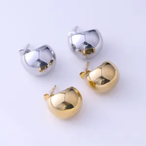 Polished silver and gold lava style irregular heart stud earrings on flat background