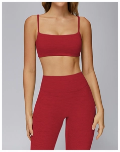 Detail of heather red yoga set showing high-stretch brushed fabric and cross-back sports bra