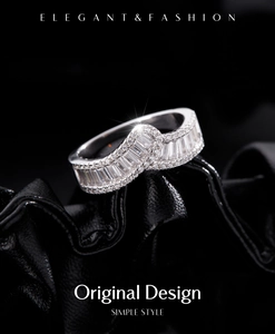 Macro shot of silver baguette-cut and pavé diamond ring on black leather texture