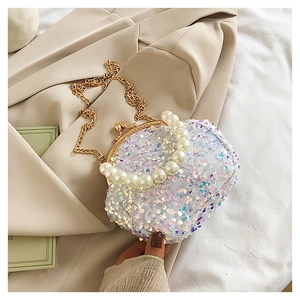 Detailed macro view of sparkling sequins and large pearl handle on elegant evening bag