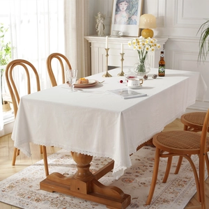 Minimalist white rectangular cotton tablecloth with elegant lace trim in a French rustic setting