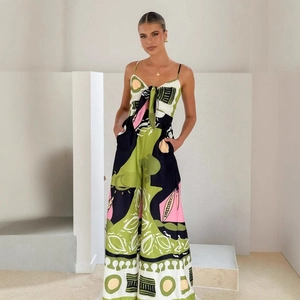 Detail of high-waist wide-leg jumpsuit featuring tropical digital print and lace-up neck