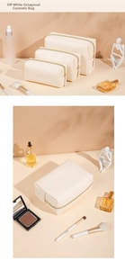 Detailed view of cream leather octagonal makeup bags with fine texture and gold zippers