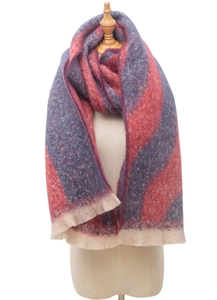 Detail of red and blue wavy knit pattern on a thick jacquard scarf with beige tassels