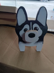 Macro view of a handcrafted wooden husky dog eyeglass stand holder ornament