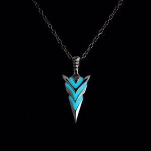 Macro detail of arrow pendant with glowing blue stripes and vintage metal finish