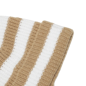 Close-up of the beige and white striped knit texture and soft material of the hat