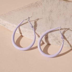 Detail of lavender purple teardrop earrings with matte finish on a stone display board
