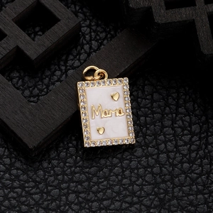 Macro shot of gold-plated Mama pendant with rectangle zircon frame on dark leather