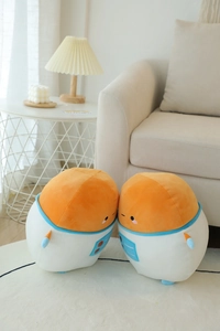 Close-up of cute plush astronaut pillows on a white rug with soft home background