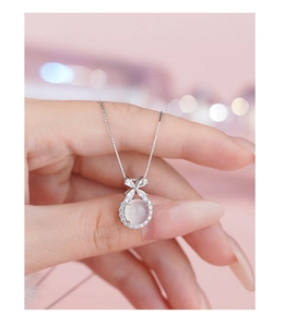 Close-up of S925 silver necklace with butterfly bow pendant and white agate stone