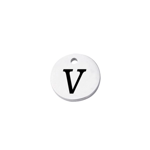 Close-up of polished stainless steel round tag featuring a stamped uppercase letter V