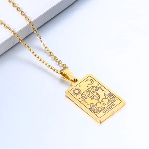 Detailed macro shot of a gold Gemini zodiac pendant with celestial engravings