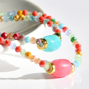 Macro view of colorful beaded necklace with faceted stones and smooth oval gems