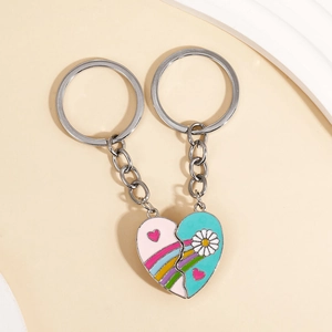 Detail of magnetic rainbow heart keychains with pink and blue enamel floral patterns