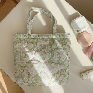 Detail of floral quilted handbag with simple wish tag and soft natural window light