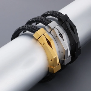 Detail of woven leather bracelets with silver, gold, and black geometric metal clasps