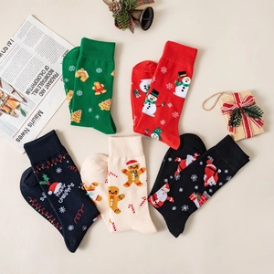 Close-up of five pairs of colorful knitted Christmas socks with Santa and snowman patterns