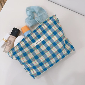 Blue plaid canvas makeup bag with floral patterns and a simple wish label on top