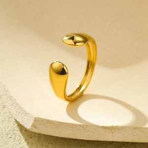 Detail of 18k gold irregular teardrop open ring with a high polished mirror finish
