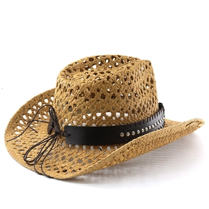 Detail of hollow woven straw cowboy hat featuring studded leather band and rivet accents