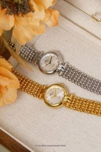 Detail view of gold and silver quartz watches with rhinestone dial in a gift box