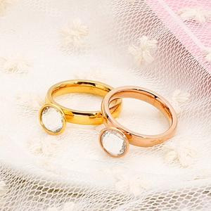 Elegant gold and rose gold stainless steel rings with round crystal on lace background