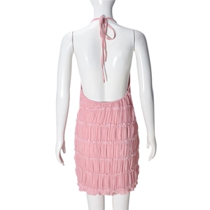 Detail of pink backless halter dress with horizontal pleats on a white mannequin