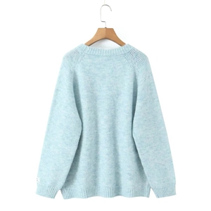 Detail view of light blue mohair knit sweater back with ribbed hem and cuffs