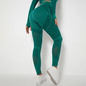 Detailed texture of green seamless knitted yoga leggings with breathable vertical stripes