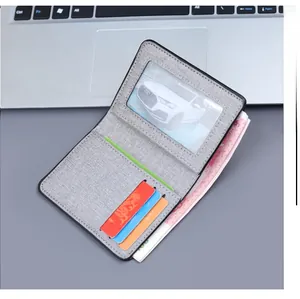 Internal view of a grey canvas bi-fold wallet showing ID window and card slots