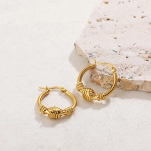 Detailed macro view of 18K gold plated stainless steel hoop earrings with a twisted knot design