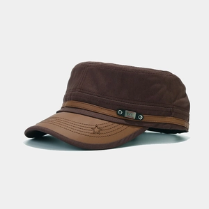 Detail of vintage cadet cap with leather strap, metal plate, and star embroidery
