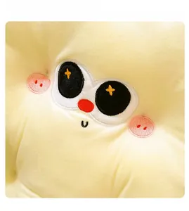 Macro shot of embroidery detail showing cartoon facial expressions on plush cookie cushion