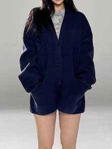 Navy blue oversized knit cardigan with chunky buttons and large pockets for women