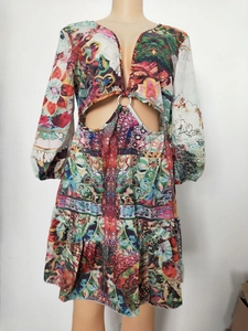 Macro detail of V-neck and hollow waist with metal ring on landscape print dress