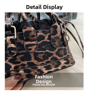 Close-up of leopard print handbag with metal ring handles and drawstring closure