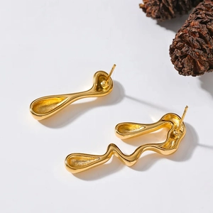 Modern fluid gold-plated earrings with irregular liquid metal design on white background