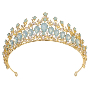 Detailed close-up of a gold bridal crown with blue opals and shimmering crystals