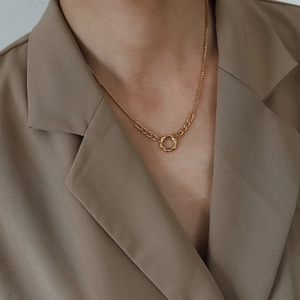 Close-up of 18K gold-plated titanium necklace with irregular circle pendant and mixed chains