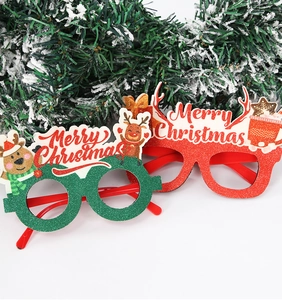 Close-up of glittery Christmas party glasses with Merry Christmas text and deer motifs