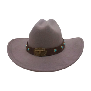 Detail of dusty rose wool felt cowboy hat featuring a leather band with bull head buckle