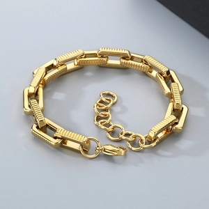 Detailed view of golden stainless steel square link bracelet with gear texture and clasp