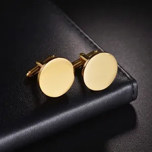 Polished gold titanium steel round cufflinks for men on a black textured leather base