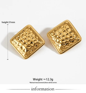 Detail of 31mm square hammered titanium steel earrings with a bright golden metallic finish