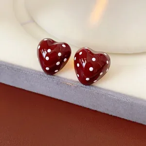 Minimalist red heart stud earrings with white polka dots and silver needle posts