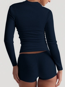 Rear view of navy blue ribbed knit yoga set showing long sleeve top and shorts
