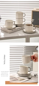 Detail of luxury ceramic coffee cup with silver handle and matching saucer set