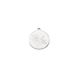 Close-up of a silver stainless steel round pendant with engraved floral pattern