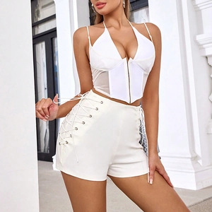 Detail of white high-waisted shorts with side drawstring and adjustable ties